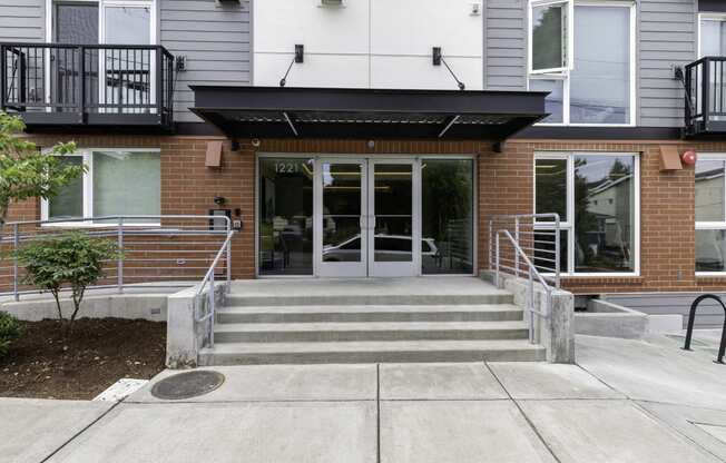 View of the front of the property entrance with a ramp and stairs leading up to the door at Arabella Apartment Homes, Washington