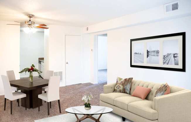 A living room with a couch, chairs, and a coffee table.