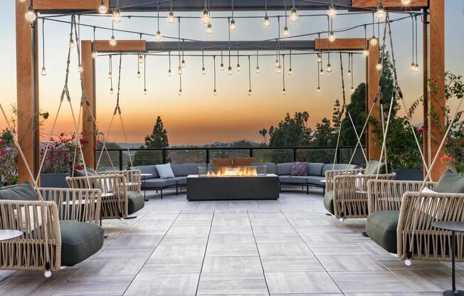 Relax at Modera Pomona's rooftop deck with a firepit and swings—perfect for sunsets, friends, and cozy nights.