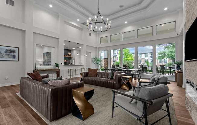 A modern living room with a brown sofa and a grey armchair.