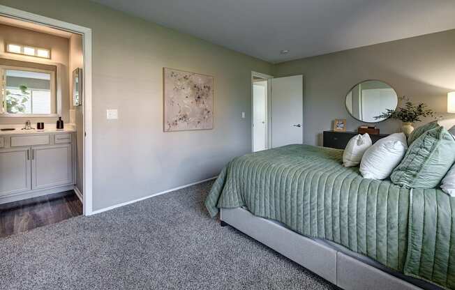 a master bedroom with a large bed and a bathroom