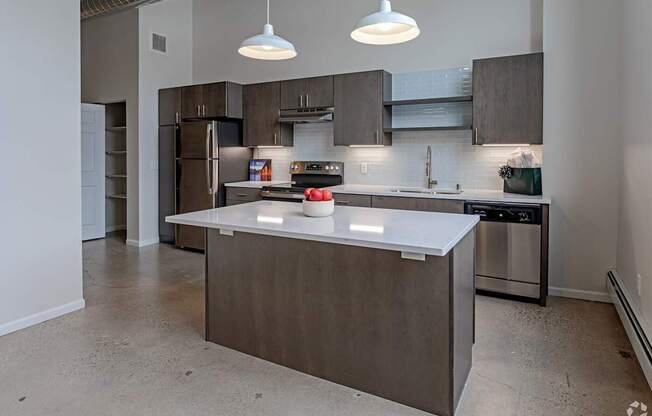 A modern kitchen with a large island in the center.