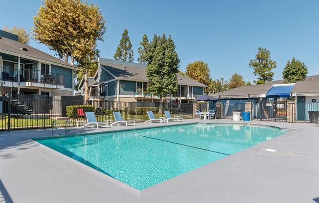 Apartments for Rent in Riverside, CA - Veranda Riverside - Sparkling Pool with Concrete Deck and Lounge Chairs.