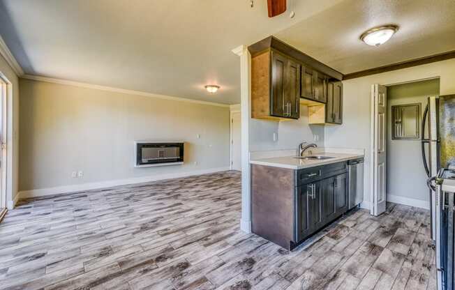 the kitchen is open to the living room and has a stainless steel appliance