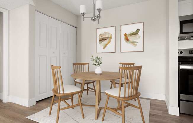 a dining room with a table and chairs and two paintings on the wall