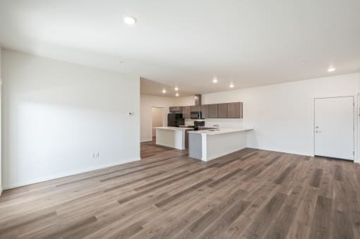 a kitchen and living room with white walls and wood flooring at Gateway Apartments, East Wenatchee , WA