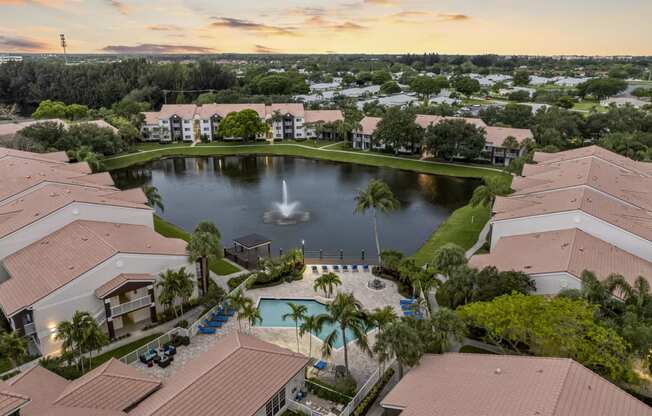 an aerial view of a fountain in the middle of a pond