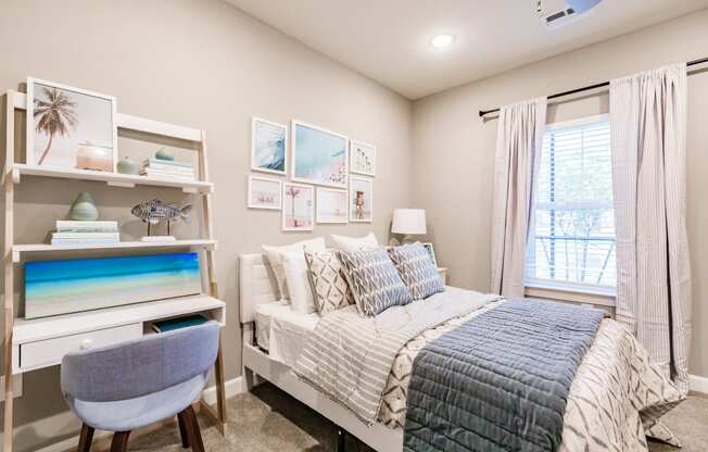 a bedroom with a bed and a desk and a window at Vantage Luxury Apartments in Cape Coral, Fl