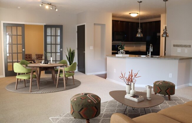 a living room and kitchen with a table and chairs