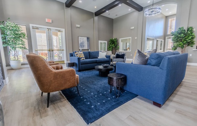 a living room with couches and chairs and a rug
