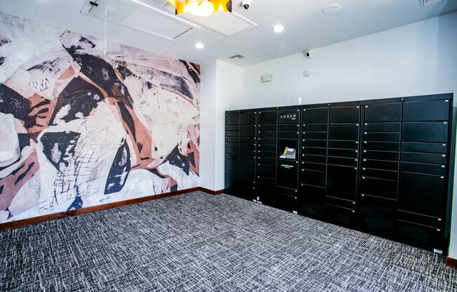 a room with black lockers and a mural on the wall