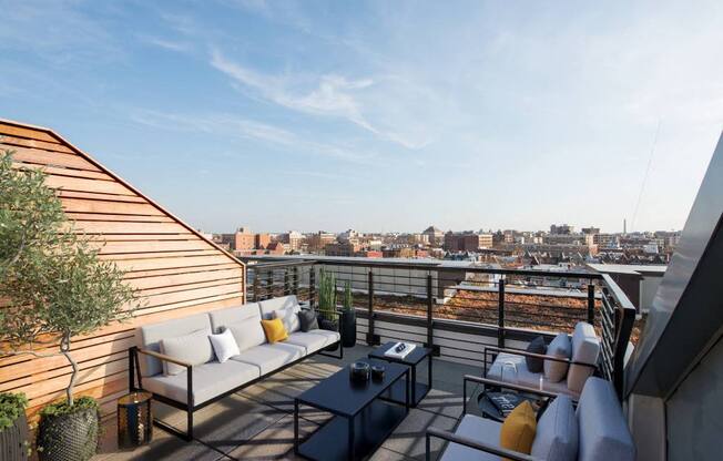 a terrace with couches and a table on a roof top  at Reed Row, Washington, 20009