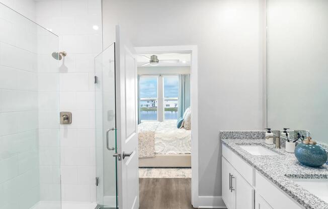 Designer bathrooms with double vanities, quartz countertops, and large mirrors
