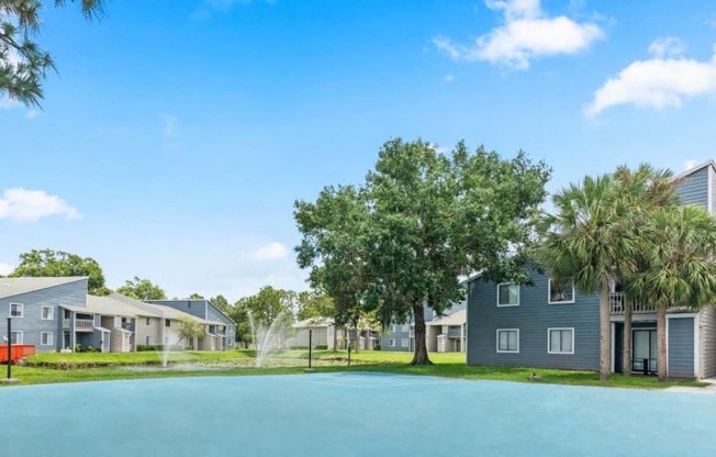 a large pool in front of a row of houses