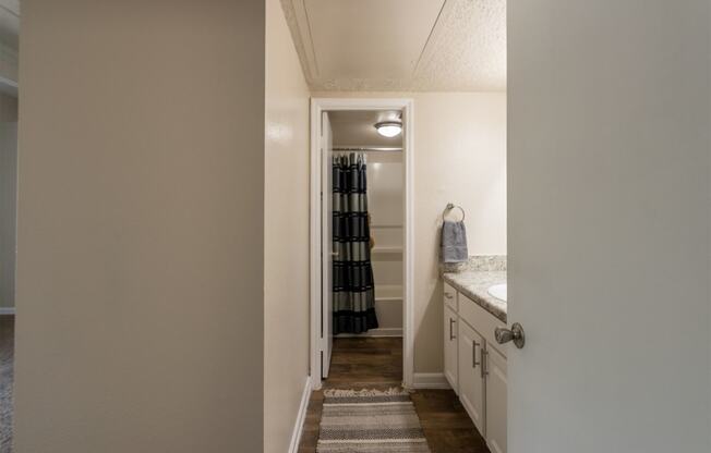 This is a photo of the primary bathroom in the 965 square foot 2 bedroom, 2 bath  apartment at Harvard Square Apartments, in Dallas, TX.