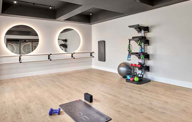 A gym with a black mat that says "GO" on it.