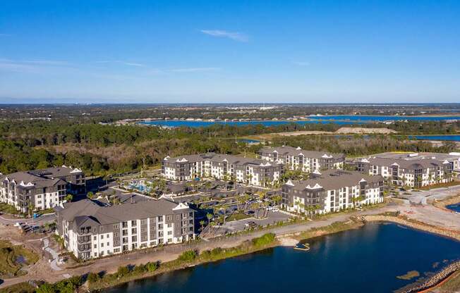 A large resort with a body of water in front of it.