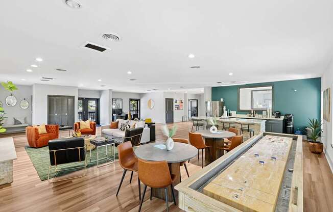 A room with a shag carpet and a shuffleboard table.