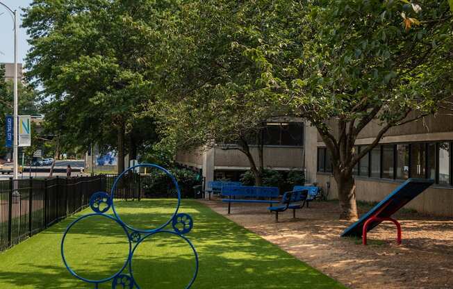 a park with a playground and a tree