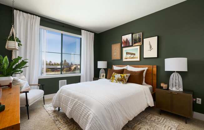 a bedroom with green walls and a white bed