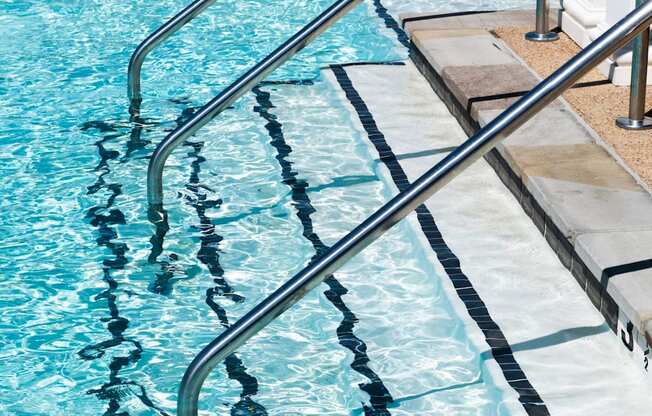 a swimming pool with stainless steel handrails at Meridian Park in Collierville, TN 38017