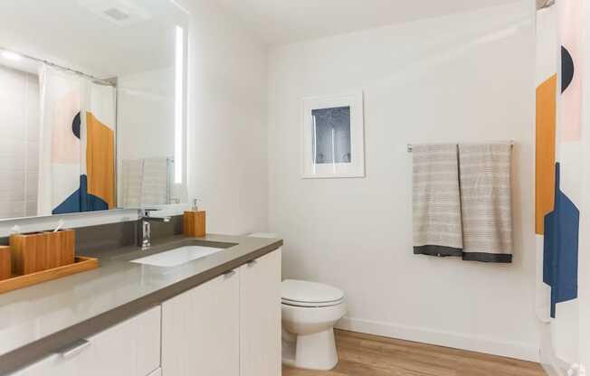 A bathroom with a white toilet and a sink.