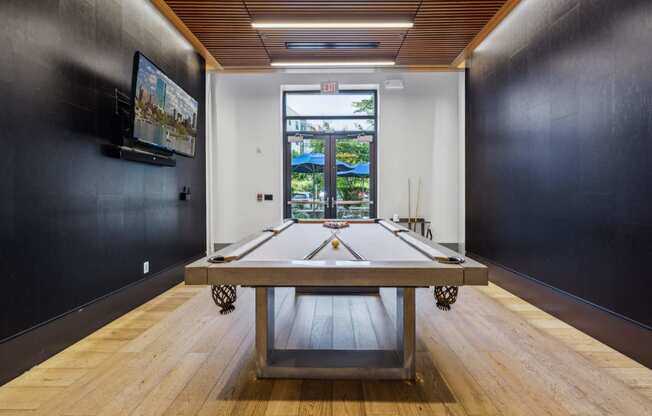 a game room with a ping pong table and a window at The Merc, Waltham, Massachusetts