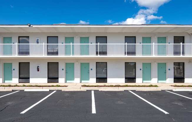 an empty parking lot in front of a building with balconies at The Teale Navy Yard, North Charleston, 29405