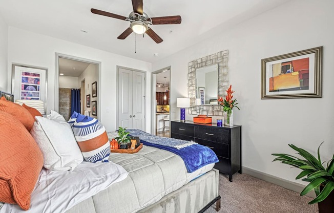Cozy bedroom with a ceiling fan and contemporary decor at Allusion at West University apartments in Houston, TX
