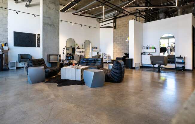 a living room with couches and tables in a warehouse