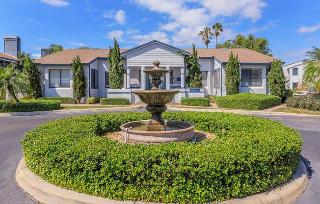 a house with bushes in front of a building