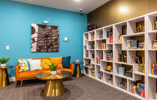 the lobby of a library with a couch and tables