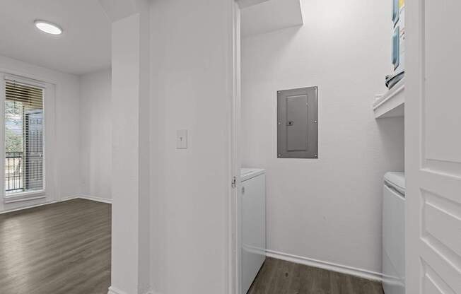 A white room with a door and a window.