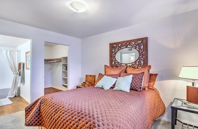 Apartments for Rent in Las Vegas-Portola Del Sol Apartments Carpeted Bedroom With Walk-In Closet And Plush Bedding