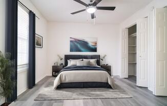 a bedroom with a bed and a ceiling fan