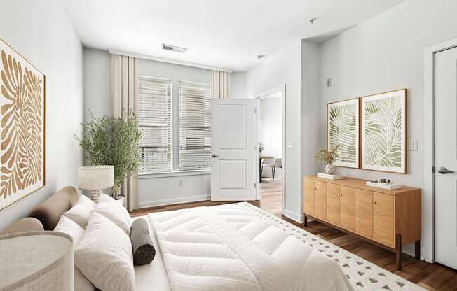 A living room with a white couch and a wooden cabinet.