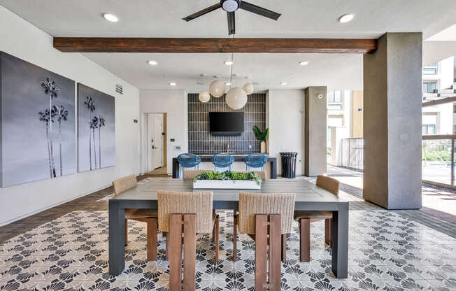 A dining room with a table set for four.