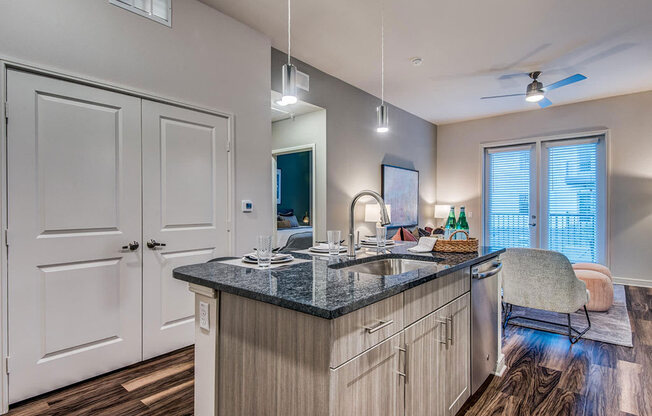 Granite counter tops, stainless appliance package, medium brown cabinets, plank wood-style flooring, island seating, abundant cabinet and pantry space