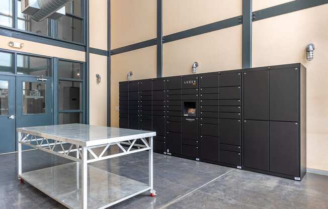 A black panelled wall in a room with a table in front of it.