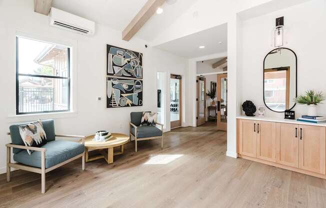A living room with a sofa, two chairs, and a coffee table.