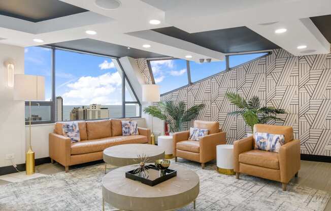 a lobby with couches and a table in front of a window