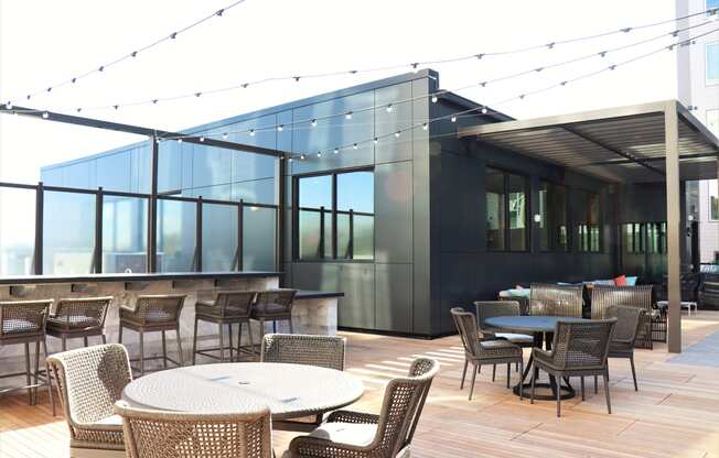 an outdoor patio with tables and chairs and a bar at Vyne One Loudoun, Ashburn, VA, 20147