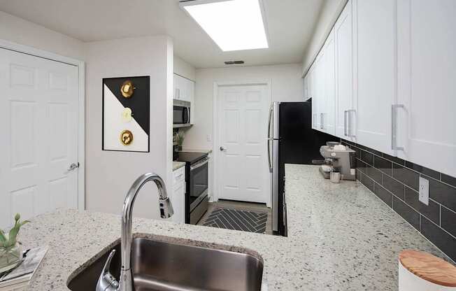 a kitchen with a sink and a refrigerator