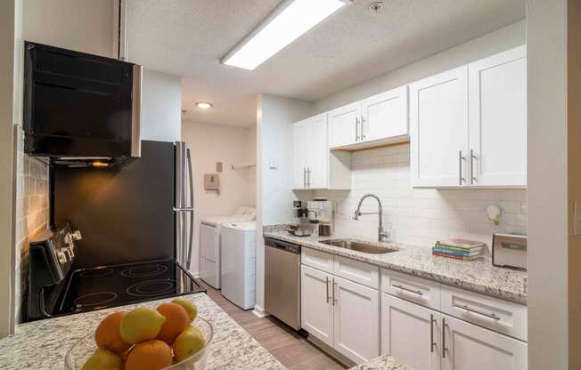 Renovated Kitchen with stainless steel appliances and granite countertops at Elme Eagles Landing in Stockbridge, GA