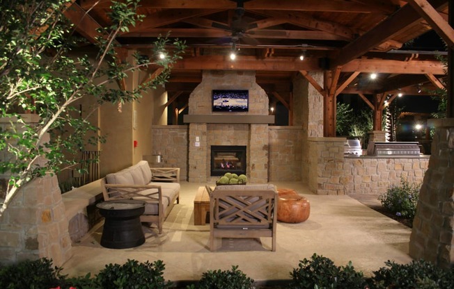 Villas at Sundance Apartments outdoor living room with a fireplace and a tv