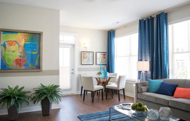 a living room and dining room with a table and chairs at GrandView Flats and Townhomes, Indiana