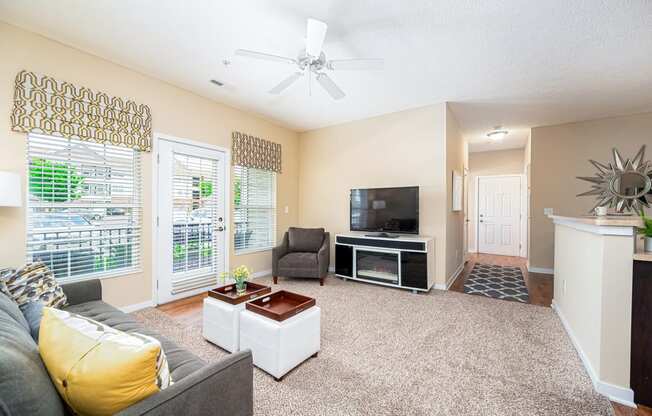 a living room with a couch and a ceiling fan