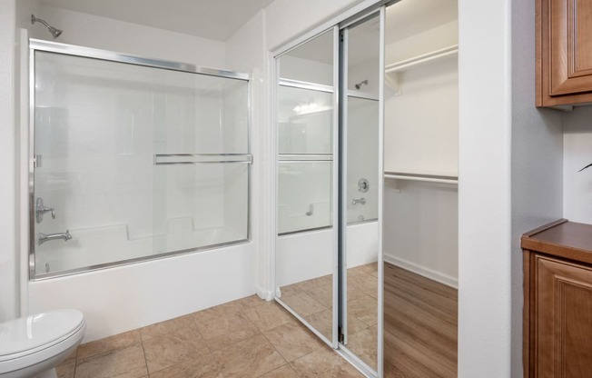 a bathroom with a shower and a toilet and a sink