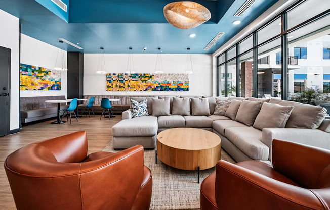 A living room with a brown leather chair and a grey sofa.