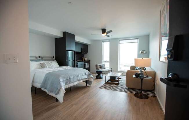 a bedroom with a bed and a living room with a window at Analog Tacoma, Washington 98402
